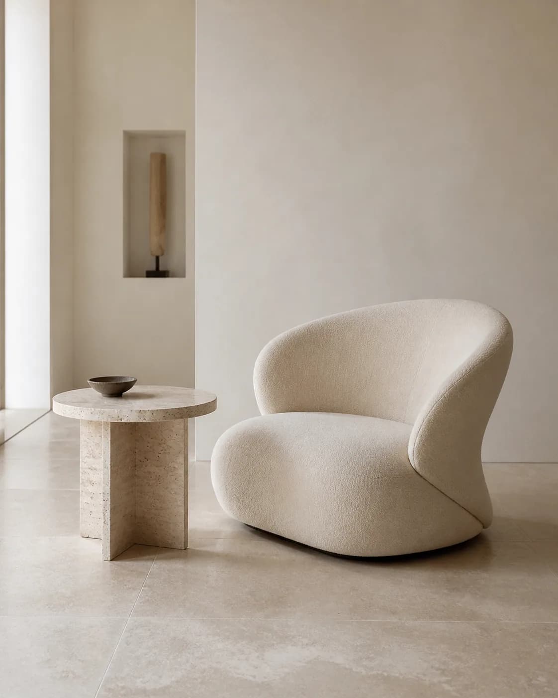 Minimalist AI prompt real output: Minimalist interior photograph of one sculptural cream lounge chair beside a travertine tab